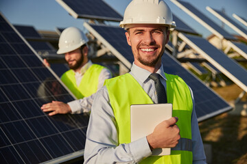 Cheerful contractor on solar farm