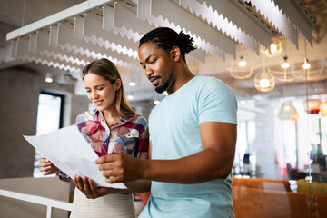 Successful group of designers, business people at work in office