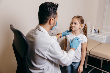 Arab or Turkish doctor examines a little girl before vaccination