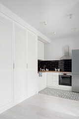 White wardrobes next to kitchen