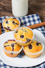 blueberry muffins with powdered sugar fresh berries