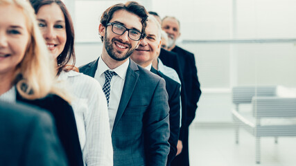 close up. group of corporate employees standing in line.