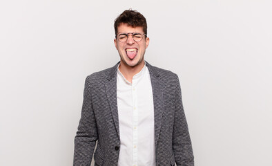 young man with cheerful, carefree, rebellious attitude, joking and sticking tongue out, having fun