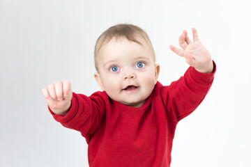 Beautiful kid pulls his hands up to his parents, white background.