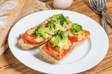 Fototapeta na wymiar open sandwich with prosciutto mozzarella tomatoes kitchen table shallow focus (3)