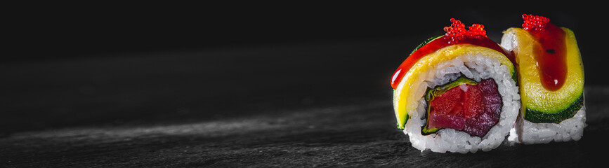 sushi roll with fish and rice on black wooden table background © pavel siamionov