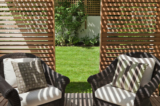 Rattan furniture in a slatted cedar garden pavilion