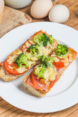 open sandwich with prosciutto mozzarella tomatoes kitchen table shallow focus (2)