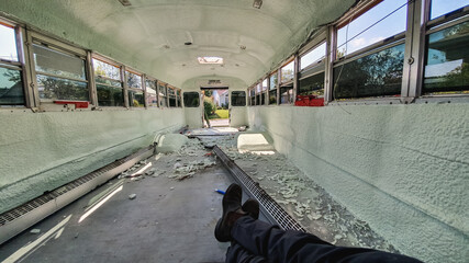 POV shot of the photographer's legs laying inside a bus in the process of being emptied, cleaned...