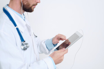 Hands of young male doctor pointing at tablet display during online consultation