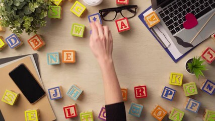 Woman hand arranging wooden cubes with word NETWORK top view - Powered by Adobe