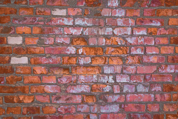 Old dirty brown brick wall with colorful paint texture background