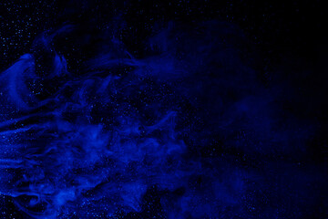 Art photo of blue smoke moves on black background. Beautiful swirling smoke.