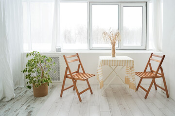 Table and two chair. Beautiful light and wooden interior. Cozy home, minimilaism. Table and two chair.