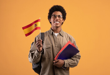 Learning new language, education and travel. Young smiling african american male with backpack hold...