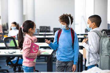International pupils wearing medical masks and talking