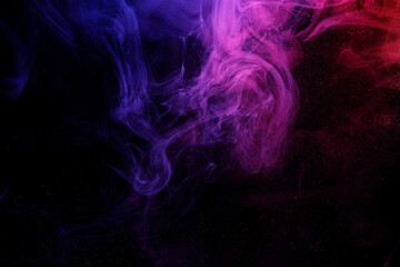 Abstract purple smoke moves on black background. Beautiful swirling smoke.