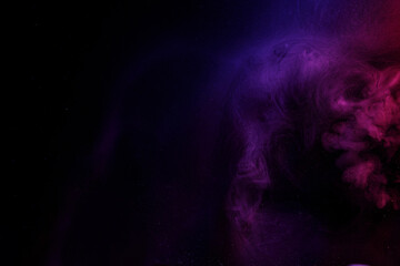 Abstract purple smoke moves on black background. Beautiful swirling smoke.