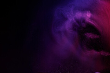 Abstract purple smoke moves on black background. Beautiful swirling smoke.