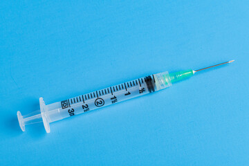 Hygienic Single-Use Disposable Syringe Injection On Blue Background