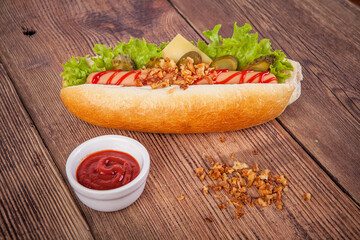Hot dog on a wooden background. View from another angle in the portfolio.