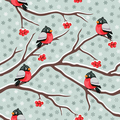 Winter theme seamless pattern with bullfinches, rowan berries and snowflakes. Vector illustration.