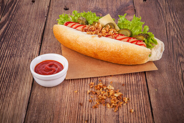 Hot dog on a wooden background. View from another angle in the portfolio.
