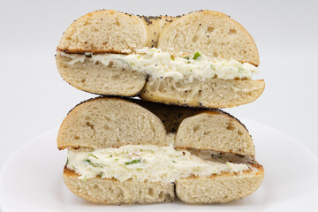 New York City Poppy Seed Bagel Cut in Half with Garlic Scallion Cream Cheese