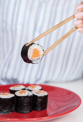 Sticks with rolls in female hands