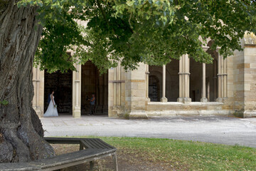 Maulbronn Monastery from outside with a bride in a white dress, Germany: Maulbronn is a former Cistercian abbey and one of the best-preserved in Europe, was named a UNESCO World Heritage Site in 1993.