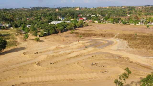 Aerial view of Motorcycle racers train on the motocross track, among the sand hills. Cagayan de Oro, Mindanao, Philippines.