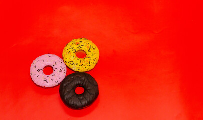 Colorful donuts on a red background