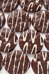 Cookies covered with chocolate on white background