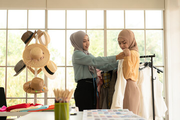 Both Muslim women run a small business in their own homes. Is the design and tailoring of clothes.