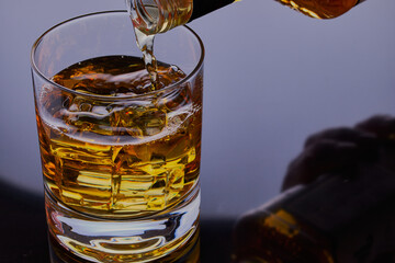 Whisky being poured in to  a glass.