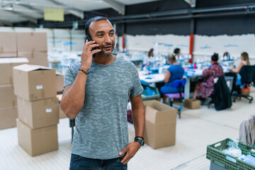 middle-aged factory manager talking on the phone