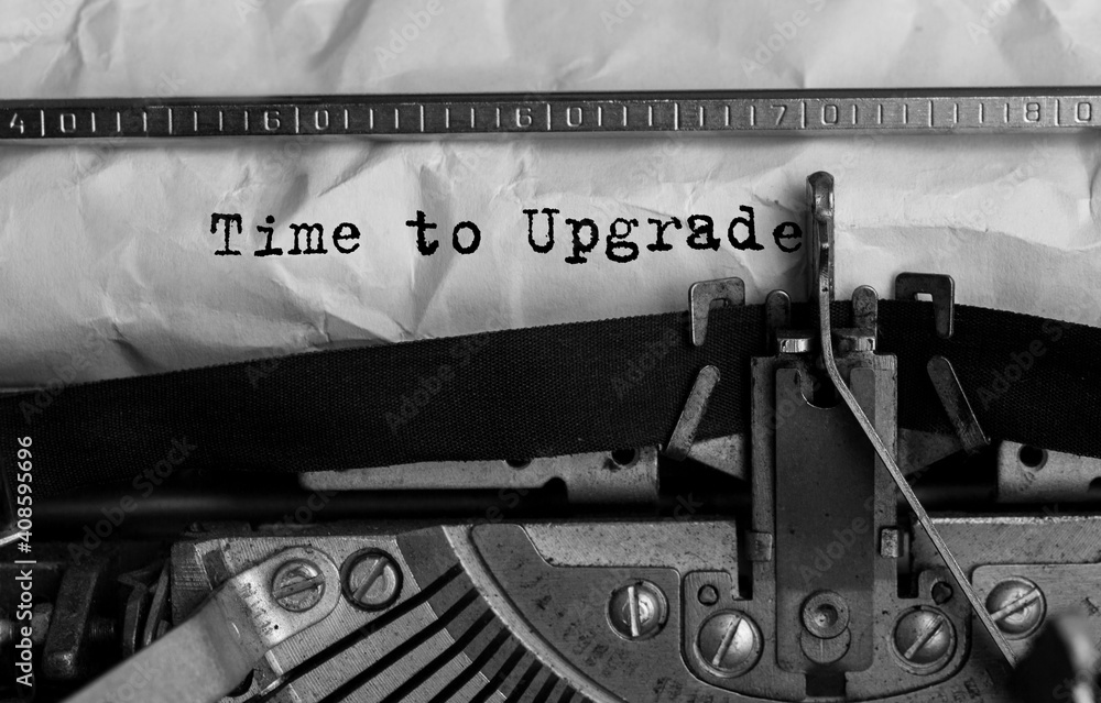 Poster text time to upgrade typed on retro typewriter