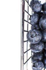 Top view of a fresh blueberries in a metal shopping box isolated on a white background. Vitamin cocktail.