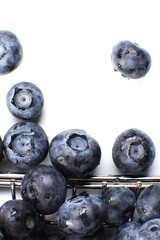 Top view of a fresh blueberries in a metal shopping box isolated on a white background. Vitamin cocktail.