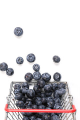 Top view of a fresh blueberries in a metal shopping box isolated on a white background. Vitamin cocktail.