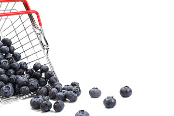 Fresh blueberries falling from metal shopping box isolated on a white background. 