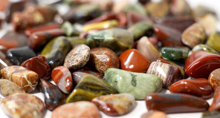 Red and multicolored jasper polished tumblestones narrow focus line, shallow depth of field macrophoto