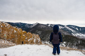 boy traveler on top of a cliff