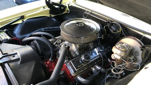 Under hood of classic car with engine, medium shot time lapse