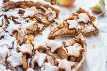 Traditional apple pie on the table with decorations.