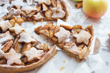 Traditional apple pie on the table with decorations.