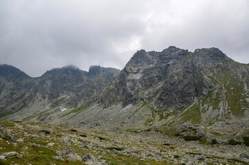 Amazing landscape with cloudy sky over majestic high rocky mountains in High Tatras, Slovakia
