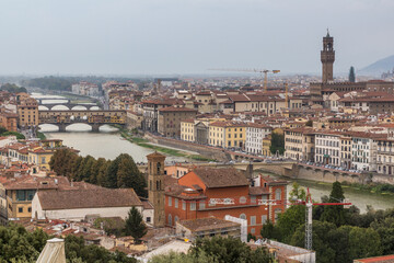 Fototapeta na wymiar Aerial view of Florence, Italy. Ponte Vecchio (Old Bridge) over the Arno River and the Palazzo Vecchio, town hall.