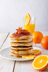 Pancake tower with orange marmalade, fresh oranges and juice for breakfast