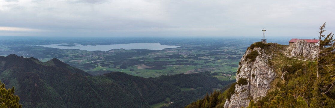 Summit cross at mountain Hochfelln with lake Chiemsee view in Bavaria, Germany